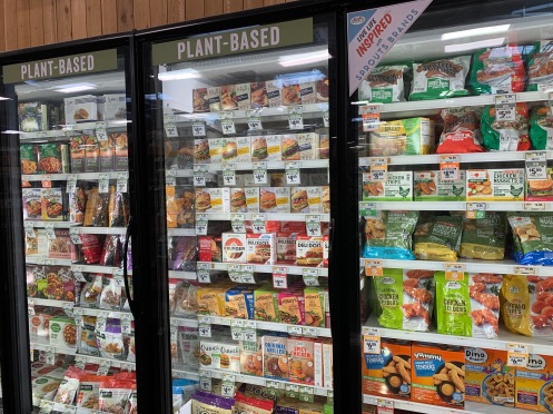 wide range of frozen foods in standing glass display cases