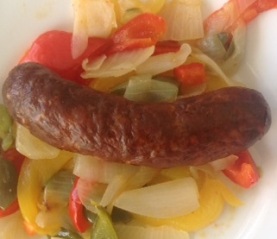 plate of cooked chorizo, peppers, and onions