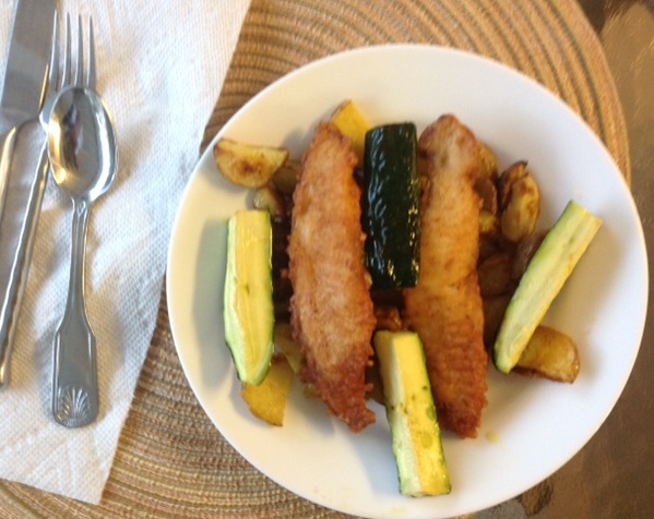 plate of zucchini, potatoes and breaded fish